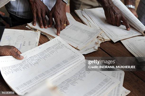 Ethnic Sri Lankan war displaced Tamils search for their names in electoral lists at the post office in Vavuniya on January 26, 2010. Voting ended...