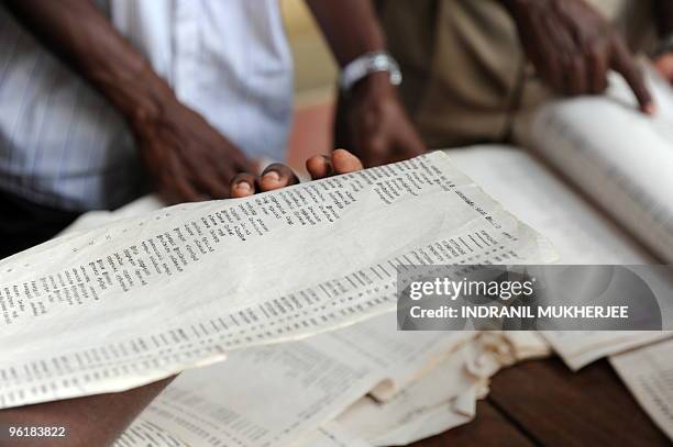 Ethnic Sri Lankan war displaced Tamils search for their names in electoral lists at the post office in Vavuniya on January 26, 2010. Voting ended...