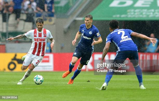 Leonardo Bittencourtof Koeln, Leon Goretzka of Schalke and Weston McKennie of Schalke battle for the ball during the Bundesliga match between 1. FC...