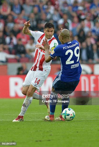 Jonas Hector of Koeln and Naldo of Schalke battle for the ball during the Bundesliga match between 1. FC Koeln and FC Schalke 04 at...