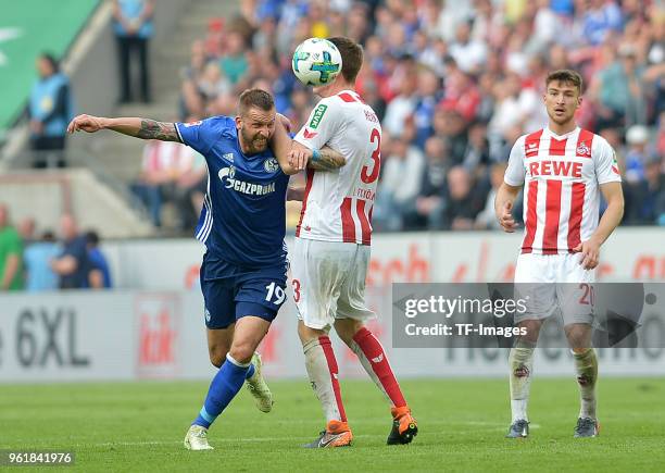 Guido Burgstaller of Schalke and Dominique Heintz of Koeln battle for the ball during the Bundesliga match between 1. FC Koeln and FC Schalke 04 at...