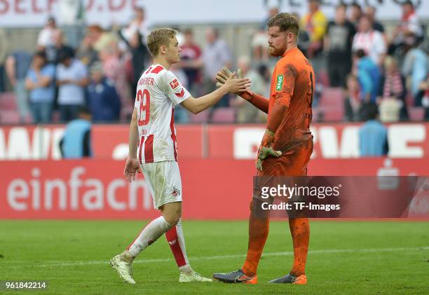 Tim Handwerker of Koeln and Goalkeeper Timo Horn of Koeln slap hands after the Bundesliga match between 1. FC Koeln and FC Schalke 04 at...