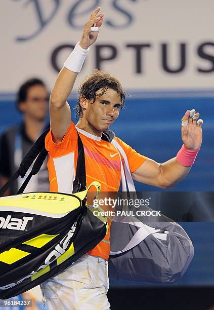 Rafael Nadal of Spain waves goodbye to the crowd following his loss to Andy Murray of Britain after he retired injured in their men's singles...