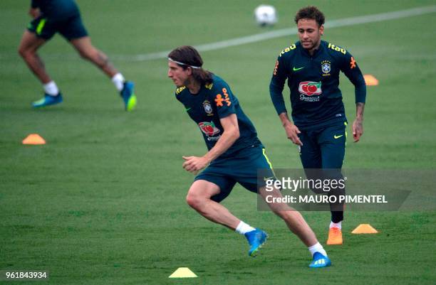 Brazil's players Neymar and Filipe Luis attend a training session of the national football team ahead of FIFA's 2018 World Cup, at Granja Comary...