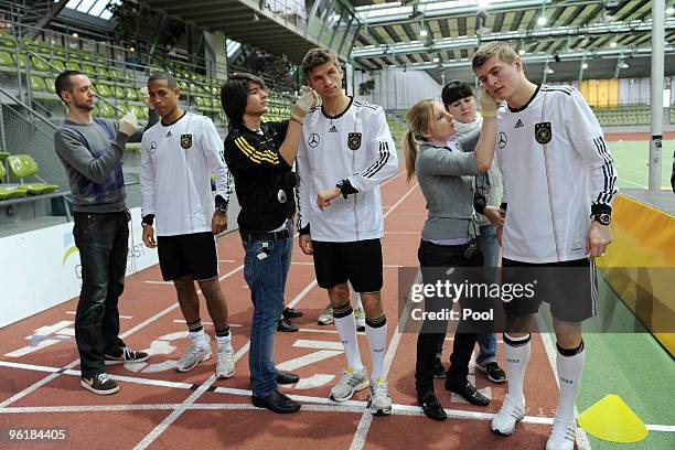 Dennis Aogo, Thomas Mueller and Toni Kroos of the German national football team are seen during the taking of a blood sample during a fitness test at...