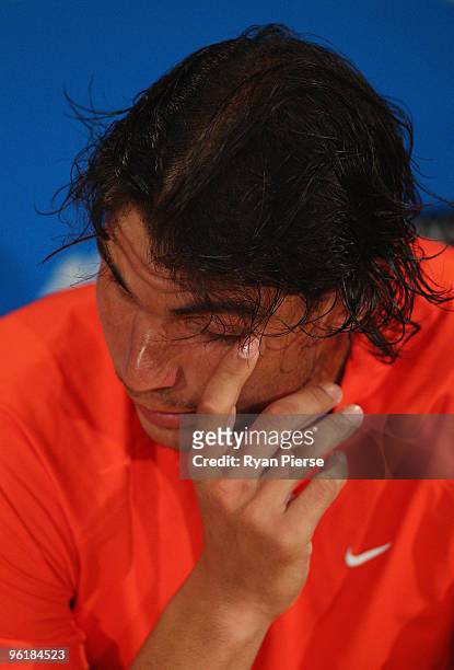 Rafael Nadal of Spain talks to the media at a press conference after retiring from his quarterfinal match against Andy Murray of Great Britain during...