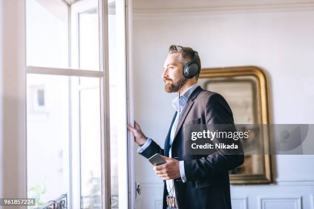 bearded man listening music with headphones - the soundtrack of my life stock pictures, royalty-free photos & images