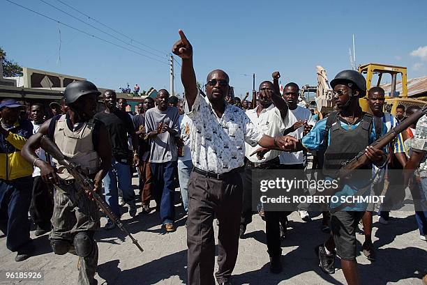 Buteur Metayer a leader of the Anti-Aristide Resistance Front, marches surrouded by armed rebels during a small demonstration in the streets of...