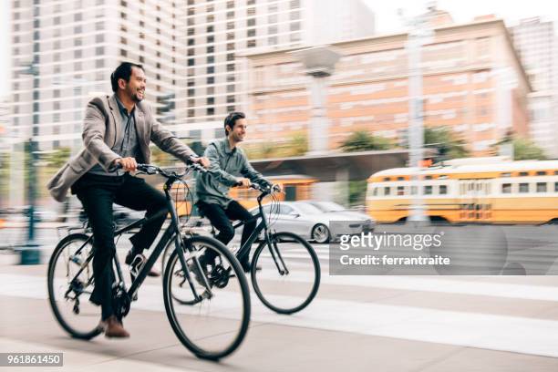 commuting with work partner by bicycle - city life stock pictures, royalty-free photos & images