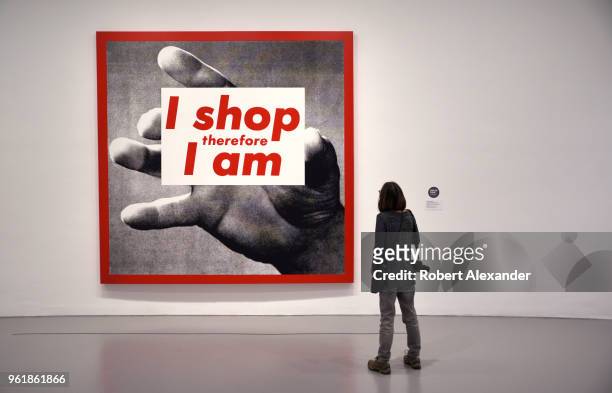 Museum visitor admires a photographic silkscreen print by Barbara Kruger titled 'I Shop Therefore I Am' at the Hirshhorn Museum and Sculpture Garden...