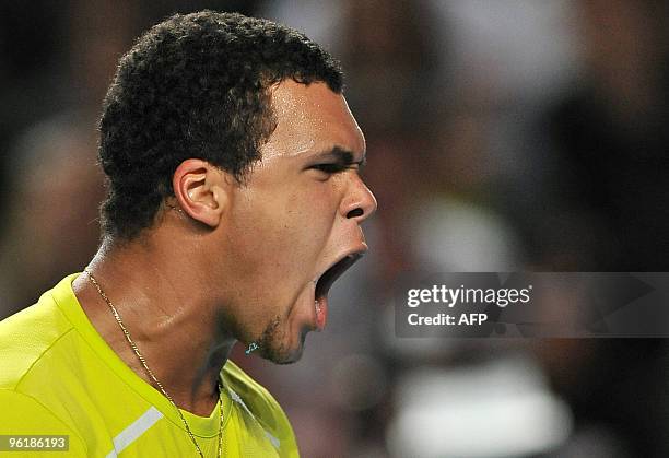 French tennis player Jo Wilfried Tsonga celebrates winning a point during his third round men's singles match against German opponent Tommy Haas at...