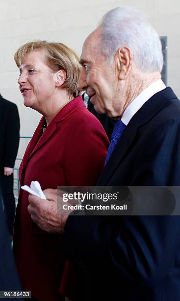 Israeli President Shimon Peres and German Chancellor Angela Merkel leave the press conference at the Chancellery on January 26, 2010 in Berlin,...