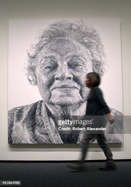 Museum visitor walks in front of a 1985 painting by Chuck Close titled 'Fanny/Fingerpainting' at the National Gallery of Art East Building on the...