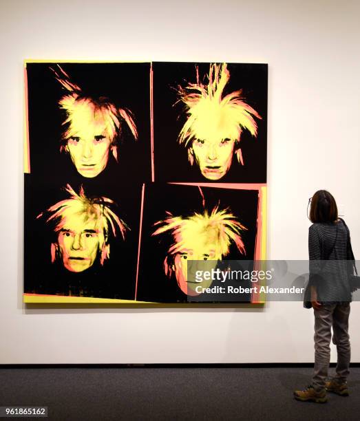 Museum visitor admires a 1986 self-portrait painting by Andy Warhol at the National Gallery of Art East Building on the National Mall in Washington,...