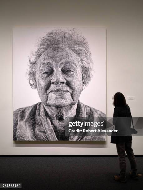 Museum admires a 1985 painting by Chuck Close titled 'Fanny/Fingerpainting' at the National Gallery of Art East Building on the National Mall in...