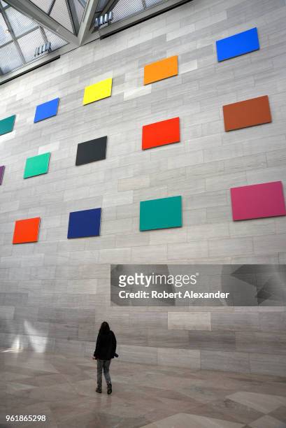 Museum visitor admires site-specific artwork by Barnett Newman covering an entire wall at the National Gallery of Art East Building on the National...