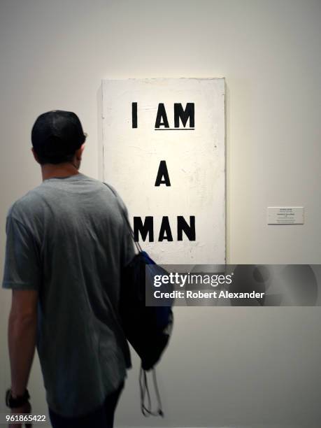 Museum looks at a 1988 painting by Glenn Ligon titled 'I Am a Man' at the National Gallery of Art East Building on the National Mall in Washington,...