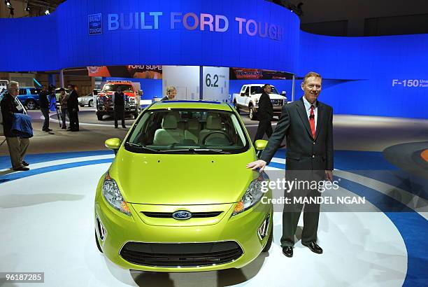 Ford Motor Company President and CEO Alan Mullaly poses next to a Ford Fiesta SES after speaking January 26, 2010 at the Washington Auto Show at the...