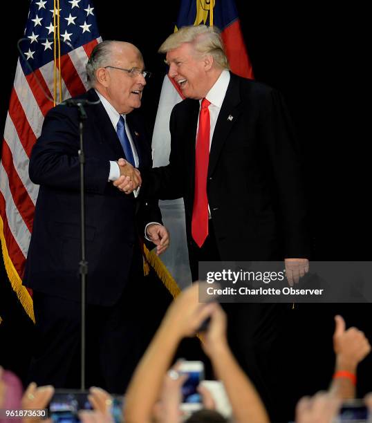 Former New York City mayor Rudy Giuliani, left, welcomes Republican presidential candidate Donald Trump on stage during a campaign rally on Aug. 18...