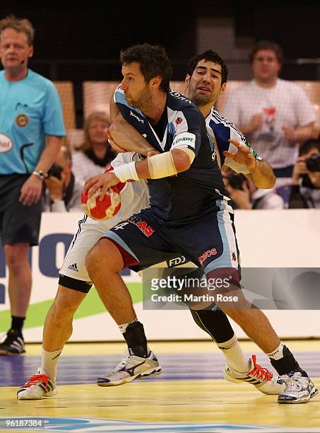 Renato Vugrinec of Slovenia in action with Nikola Karabatic of France during the Men's Handball European main round Group II match between Slovenia...