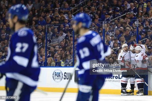 Alex Ovechkin of the Washington Capitals celebrates with his teammates Matt Niskanen and Dmitry Orlov after scoring a goal on Andrei Vasilevskiy of...