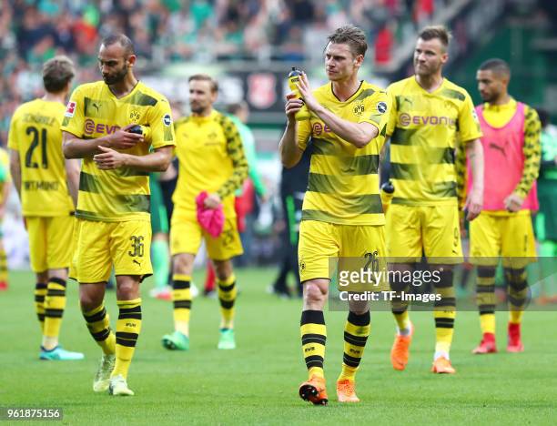 Oemer Toprak of Dortmund, Lukasz Piszczek of Dortmund and Andrey Yarmolenko of Dortmund look dejected after the Bundesliga match between SV Werder...