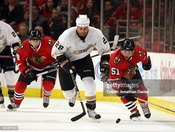 Brian Campbell and Patrick Kane of the Chicago Blackhawks chase Kyle Chipchura of the Anaheim Ducks at the United Center on January 3, 2010 in...