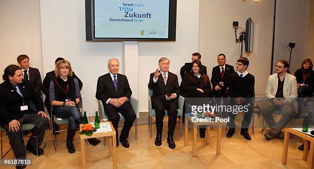 German President Horst Koehler and Israeli President Shimon Peres discus with youths at the Max-Liebermann-Haus on January 26, 2010 in Berlin,...