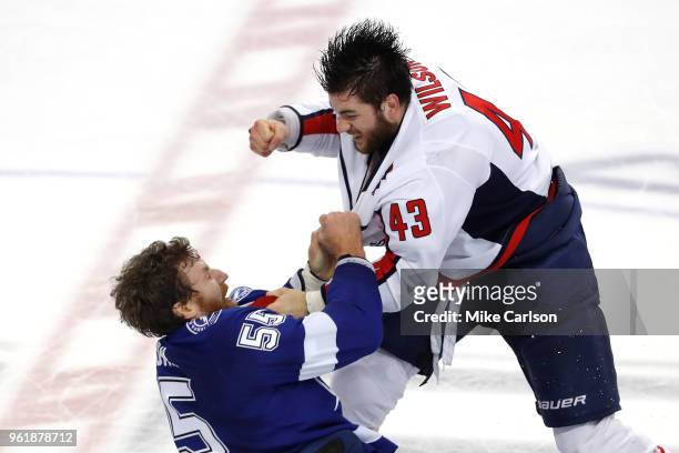 Braydon Coburn of the Tampa Bay Lightning fights with Tom Wilson of the Washington Capitals during the first period in Game Seven of the Eastern...