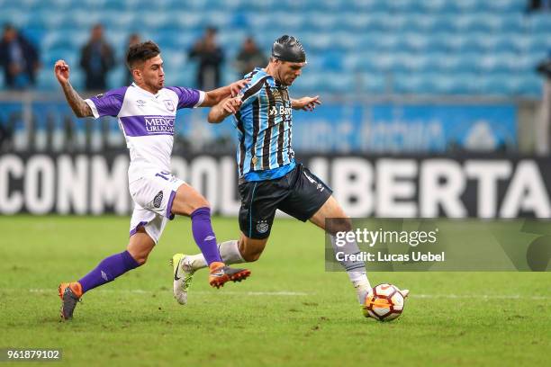 Walter Kannemann of Gremio battles for the ball against Pablo Lopez of Defensor during the match between Gremio and Defensor, part of Copa...