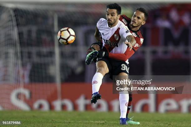 Argentina's River Plate forward Ignacio Scocco vies for the ball with Brazil's Flamengo defender Juan during their Copa Libertadores group D football...