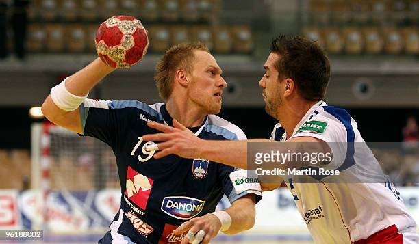 Miha Zvizej of Slovenia in action with Guillaume Gille of France during the Men's Handball European main round Group II match between Slovenia and...