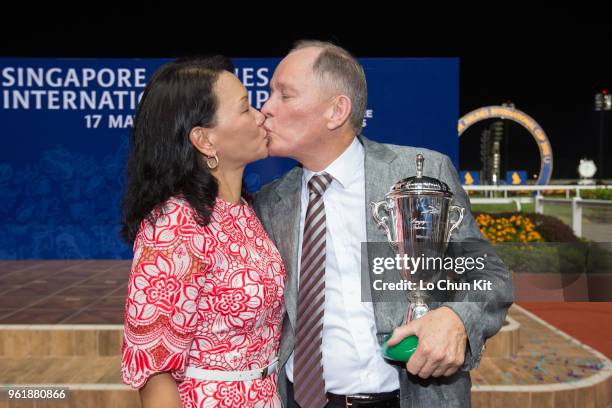 Trainer John Moore and his wife FiFi celebrate after Dan Excel winning the Singapore Airlines International Cup at Kranji Racecourse during the...