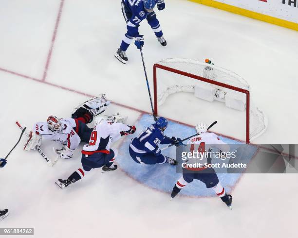 Victor Hedman of the Tampa Bay Lightning passes the puck to teammate Yanni Gourde and against goalie Braden Holtby of the Washington Capitals during...