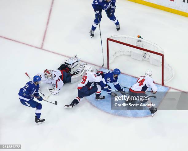 Victor Hedman of the Tampa Bay Lightning passes the puck to teammate Yanni Gourde and against goalie Braden Holtby of the Washington Capitals during...