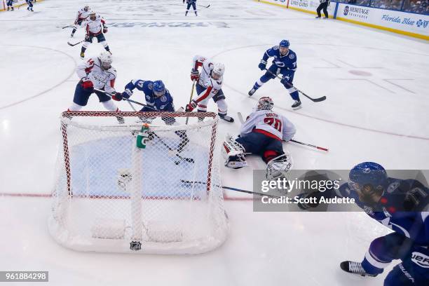 Victor Hedman of the Tampa Bay Lightning passes the puck to teammate Yanni Gourde and against goalie Braden Holtby of the Washington Capitals during...