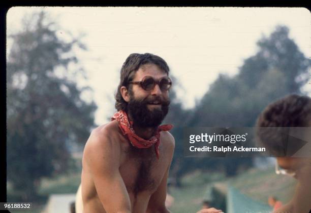 Portrait of American author and social activist Ken Babbs, shirtless, bearded, and wearing sunglasses, during the Woodstock Music and Arts Fair,...