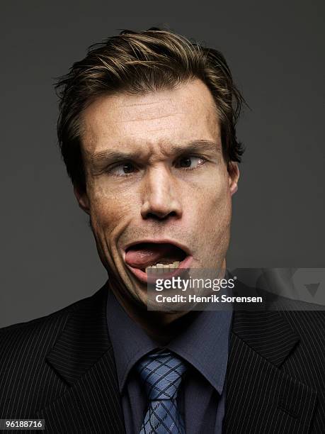 cross eyed businessman being tongue and cheek - cheek tongue stock pictures, royalty-free photos & images