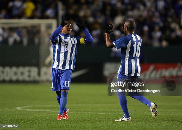 Carlos Pavon of Honduras looks to slap hands with teammate Jerry Palacios after Palacios was substituted out of their international friendly match...