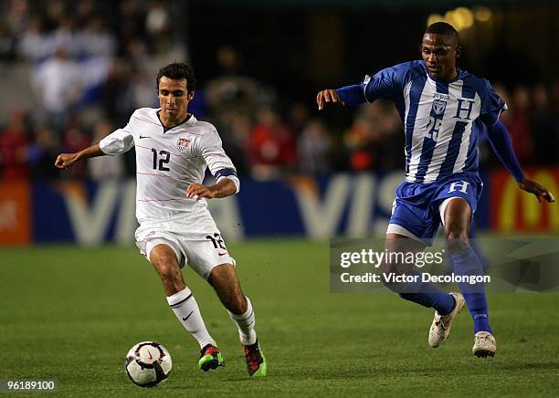 Jonathan Bornstein of USA runs back for the ball under pressure from Georgei Welcome of Honduras during their international friendly match on January...