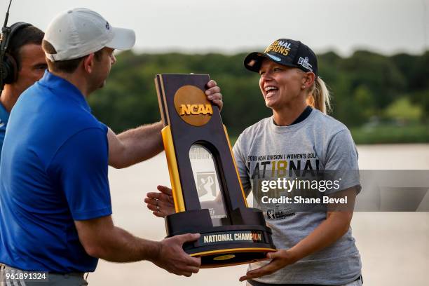 The championship trophy is presented to Arizona head coach Laura Ianello after her team won the Division I Women's Golf Team Match Play Championship...