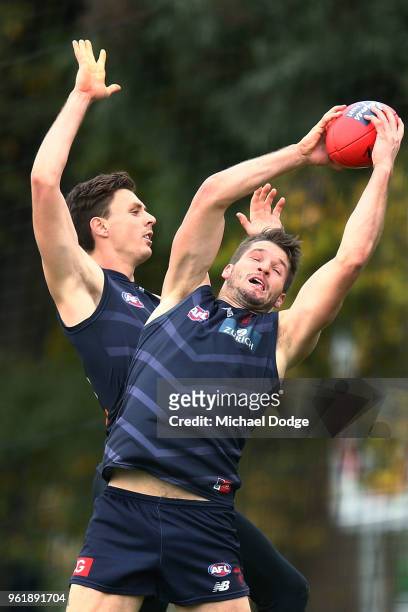 Jesse Hogan of the Demons marks the ball against Jake Lever of the Demons during a Melbourne Demons AFL training session at Gosch's Paddock on May...