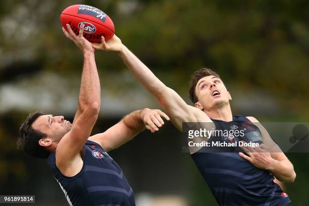 Jake Lever of the Demons and Cam Pedersen compete for the ball during a Melbourne Demons AFL training session at Gosch's Paddock on May 24, 2018 in...