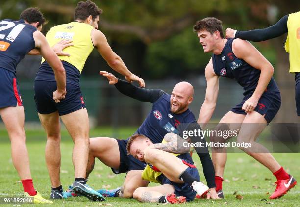 Nathan Jones of the Demons reacts after tackling James Harmes during a Melbourne Demons AFL training session at Gosch's Paddock on May 24, 2018 in...