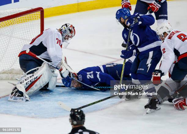 Brayden Point of the Tampa Bay Lightning falls against goalie Braden Holtby of the Washington Capitals during Game Seven of the Eastern Conference...