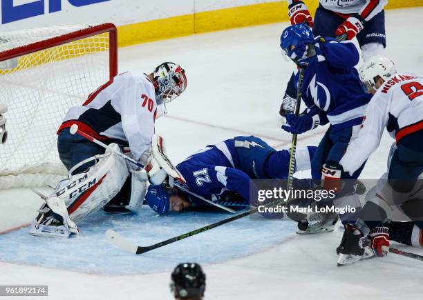 Brayden Point of the Tampa Bay Lightning falls against goalie Braden Holtby of the Washington Capitals during Game Seven of the Eastern Conference...