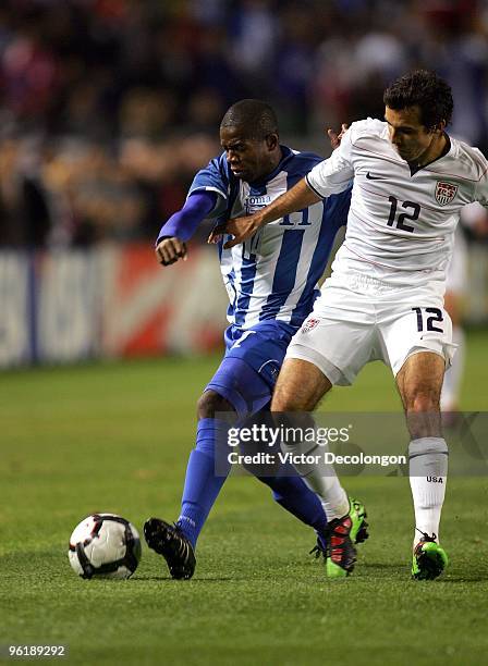 Oscar Garcia of Honduras wins the ball from Jonathan Bornstein of USA during their international friendly match on January 23, 2010 in Carson,...