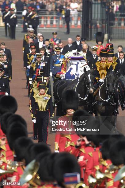 The coffin carrying the Queen Mother departs from St. James Palace, followed by members of the Royal Family.