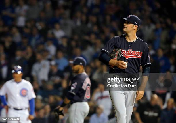Adam Plutko of the Cleveland Indians watches the replay after Willson Contreras of the Chicago Cubs singles during the seventh inning at Wrigley...