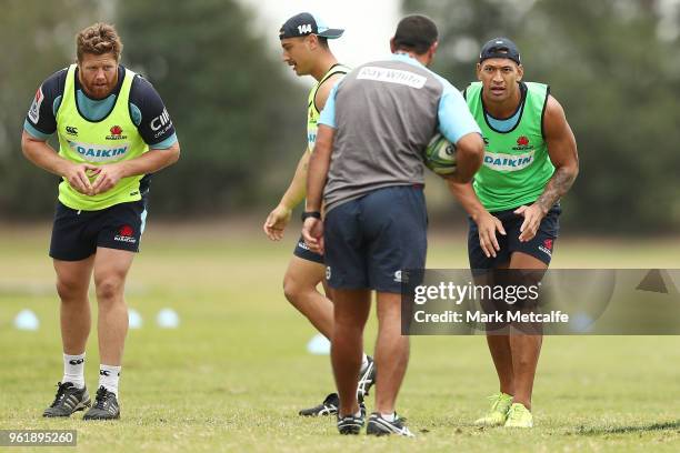 Israel Folau listens to coach Daryl Gibson during a Waratahs Super Rugby training session at David Phillips Sports Complex on May 24, 2018 in Sydney,...
